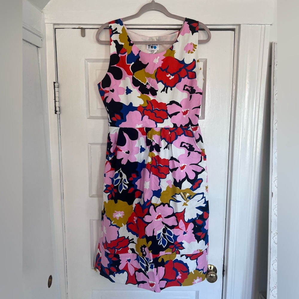 Anthropologie mini cocktail dress with cut out back and pockets